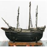 Antique ship model, of carrack form with three masts and a planked hull, rising on a deck plank