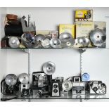 Two shelves of vintage flash cameras and equipment, consisting of Ticky and Walz flash units,