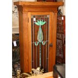 Arts and crafts leaded glass bookcase, having a single door with a floral slag glass panel, and