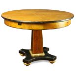 Biedermeier style center table, having a circular top, with an ebonized edge, above a pedestal