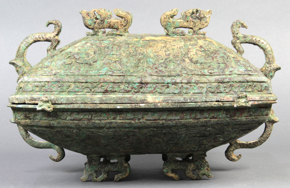 Chinese archaistic bronze covered rectangular vessel, the lid with zoomorphic finial and handles,