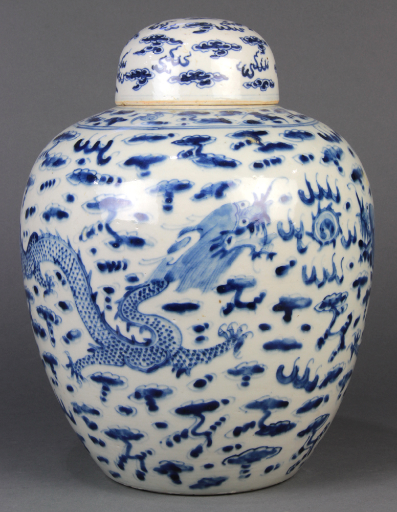 Chinese underglaze blue porcelain lidded jar, featuring a pair of writhing dragons pursuing a jewel,