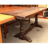Mahogany tressel dining table, rising on two carved wood supports conjoined by a lower strecher,
