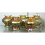 (lot of 5) Steuben glass shades, each executed in gold aurene, having a shaped and ribbed form, with