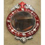 Venetian style etched glass wall mirror, having a floral decorated crest surmounting the cranberry