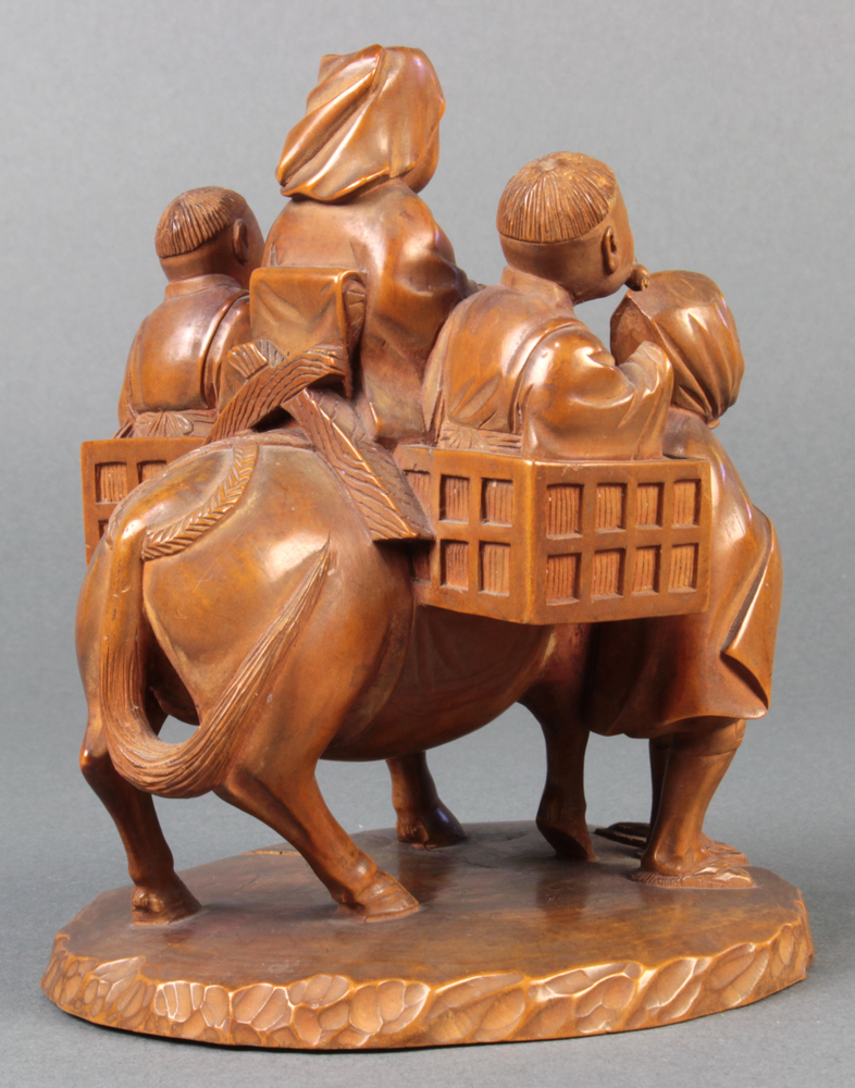 Japanese wood sculpture of tsuge wood, a woman and two boys riding on a horse, led by a smiling man, - Image 2 of 4