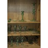 Three shelves of Murano glass, including champagne glasses and wine glasses, an urn, and a pair