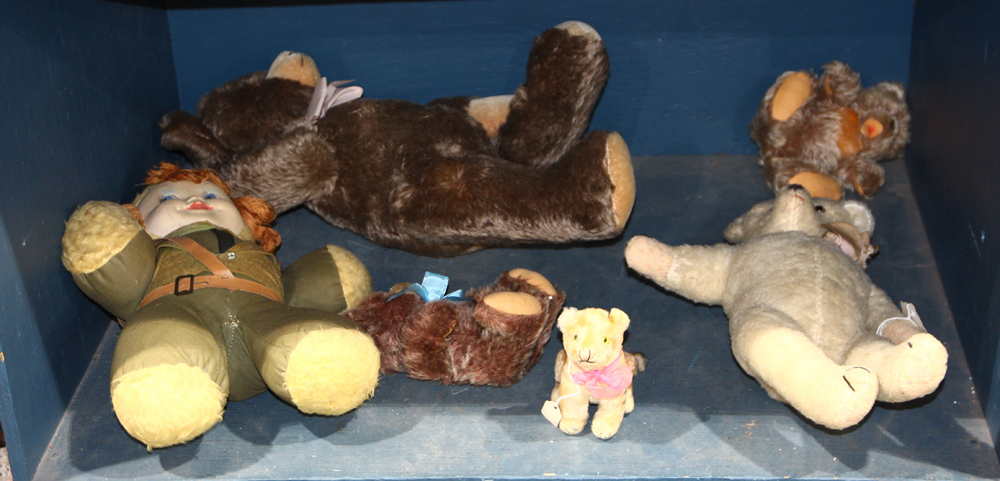 One shelf of early teddy bears and dolls in the Steiff style, largest: approximately 21"l