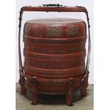 Chinese red lacquered large tiered food container, of three cylindrical stacked boxes and a lid