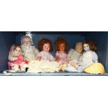 One shelf of dolls, largest approximately 21"h