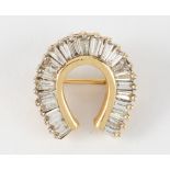 Diamond, 14k yellow gold horseshoe brooch
