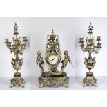 (lot of 3) Imperial partial gilt and silver clock garniture with matching seven light candelabra