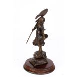 A bronze figural statue depicting a young girl fishing