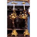 A Pair of Henri Picard patinated bronze figural candelabra