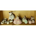 A shelf of mostly crinoline figural sculptures