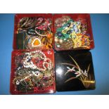 A large quantity of costume jewellery in a 3 compartment storage box
