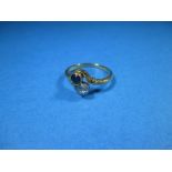 An 18ct gold ring set with a diamond and a sapphire