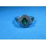 An 18ct white gold diamond and emerald ring, approx. size R