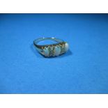 An 18ct gold ring set with diamonds and 3 opals, approx. size N