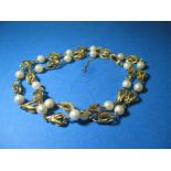 An unmarked but tested as gold and cultured pearl necklace, approx. total weight 34g