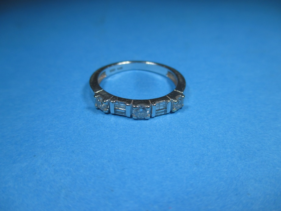 A 14ct white gold ring set with 4 baguette and 3 round cut diamonds