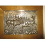 A cast metal relief wall plaque C1900, depicting a Stag, signed Oskar Pflug, in original oak frame