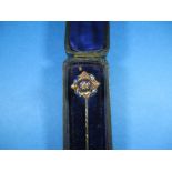 An Edwardian gold stick pin with central diamond and blue enamel decoration