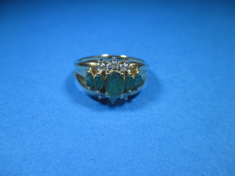 A 14ct yellow gold diamond and emerald ring, approx. size N