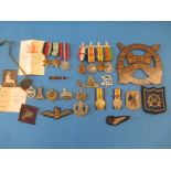 Various groups of WWI & WWII medals and badges belonging to 4 members of the same family