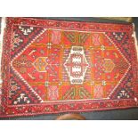 A vintage hand woven Iranian wool rug, approx size 151cm x 102cm