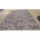 A large rug with stylised geometric pattern, approx size 19ft x 9ft