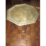 A Indian brass top folding table