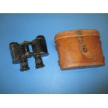 A pair of WWI military field glasses in leather case