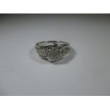 A 9ct white gold diamond cluster ring, approx size O