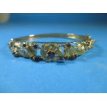 A 9ct gold garnet set bangle with box clasp, approx weight 14.6g