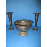 An Edwardian sterling silver bowl and a pair of silver candlesticks