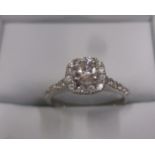 A 9ct white gold diamond cluster ring, approx size L