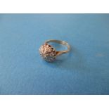 An Edwardian 15ct gold and diamond daisy ring, approx ring size O1/2