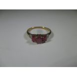 A 9ct gold ring set with Burmese rubies, approx size O