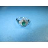 An 18ct white gold diamond and emerald ring, approx. size R