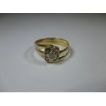 A yellow gold ring market 750 set with various stones, approx size P