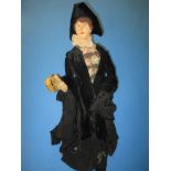 A 19th century carved wood doll in period costume, accompanying label reads Lady