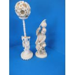 A 1920s carved ivory puzzle ball on stand and a figure of a water carrier