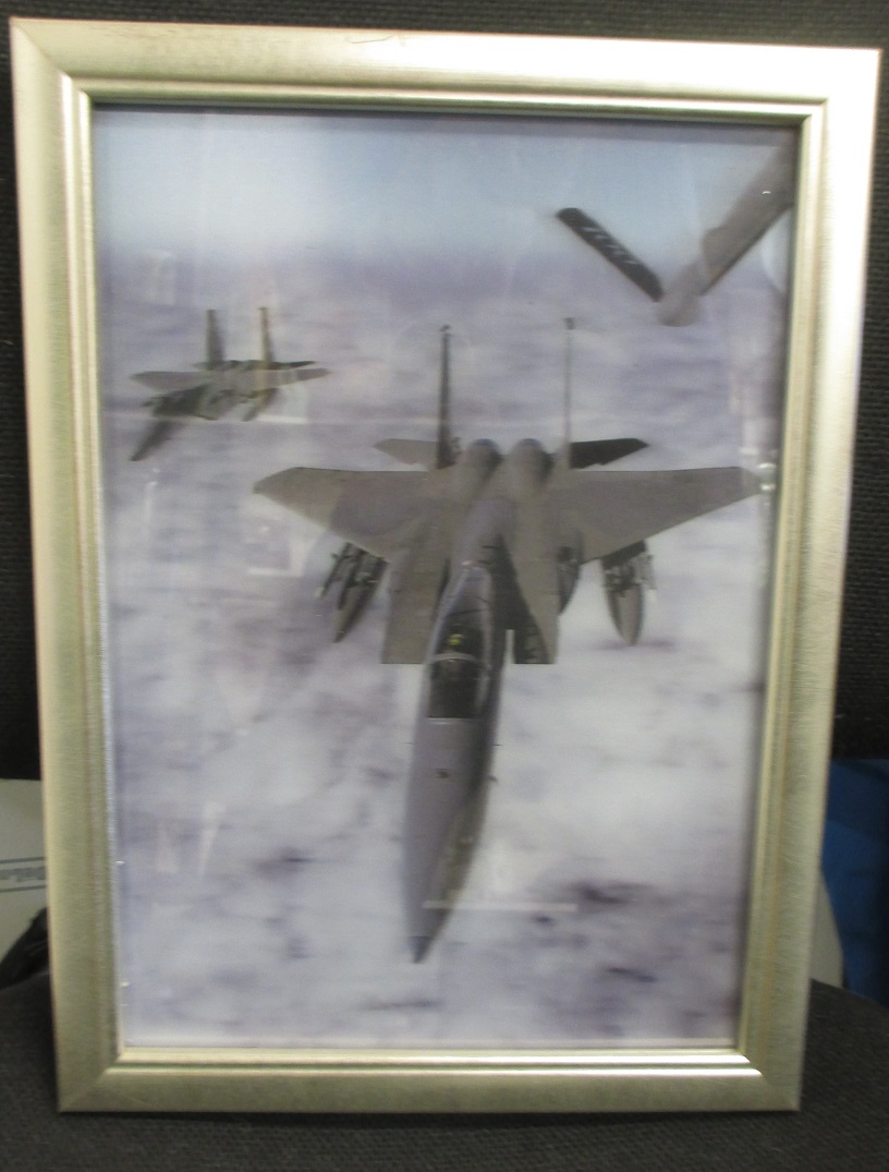 A framed 3D picture of an F15 fighter being re-fuelled in flight