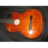 Jon Andersons electro-acoustic guitar, signed in 2010 by Jon Anderson after the