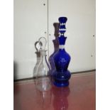 A bohemian hand blown blue glass decanter and one other . Register and bid at ht