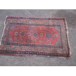 An antique Persian hand woven wool rug, approx size 82cm x 130cm
