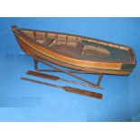 A scratch built model rowing boat on stand