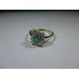 An 18ct yellow gold diamond and Emerald ring, approx size O