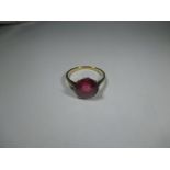 An 18ct gold and platinum ring set with a large red stone